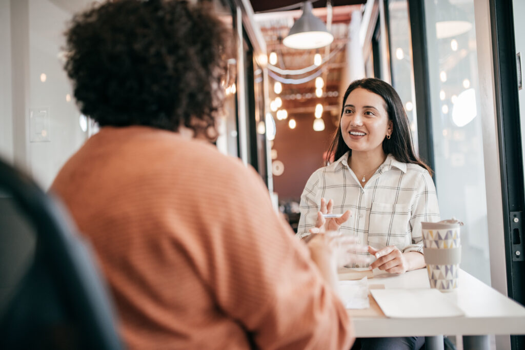 A recruiter interviewing a HR leader for an article discussing key achievements of their career