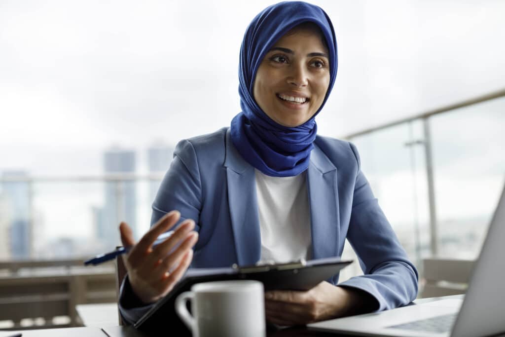 A Chief People Officer (CPO) sits at her desk on a teams call discussing recruitment processes 