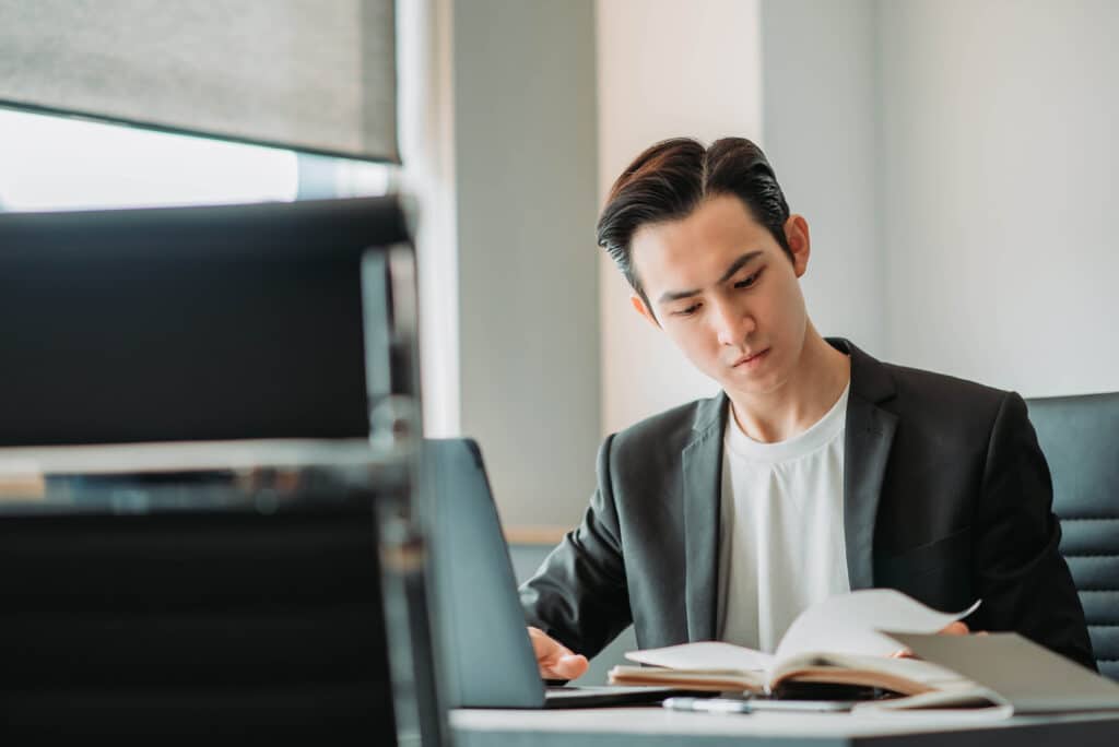 A Chief Human Resources Officer (CHRO) sits at his desk and laptop