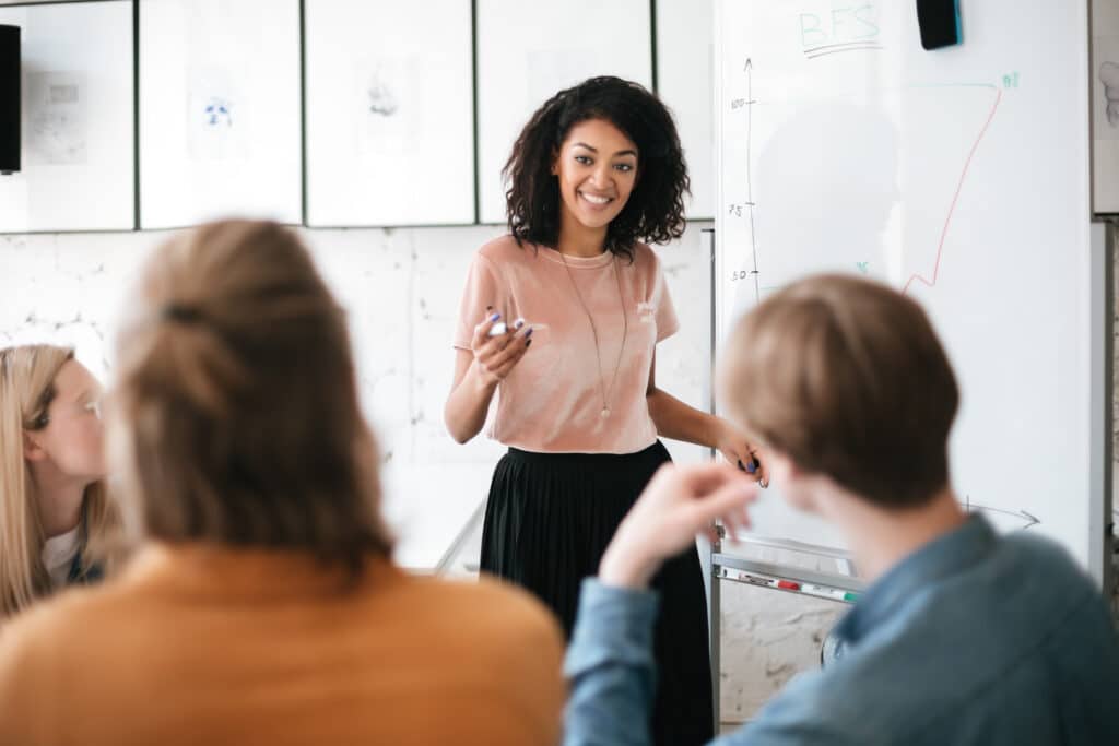 A HR leader presenting to a group of recruiters her top career advice, why she got into HR and how the industry has changed